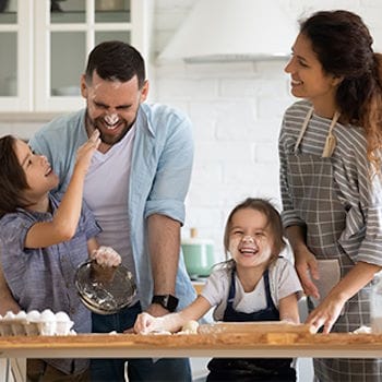Savannah having fun baking with her husband and children