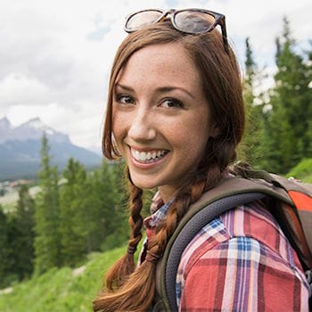 Jennifer smiling while hiking in the mountains
